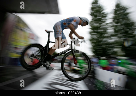 Panning shot of cyclist speeding by during a time trial Stock Photo