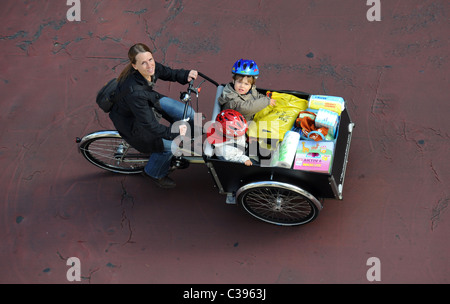 A woman with two children on a cargo bike Stock Photo