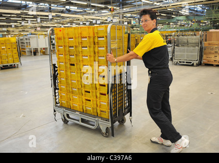An employee with a trolley in a postal sorting centre, Berlin, Germany Stock Photo