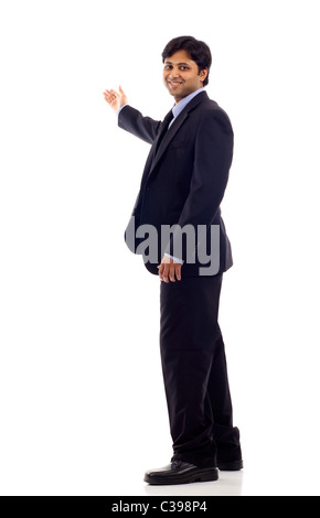Full length of a happy Indian business man presenting and showing with copy space for your text isolated on white background Stock Photo