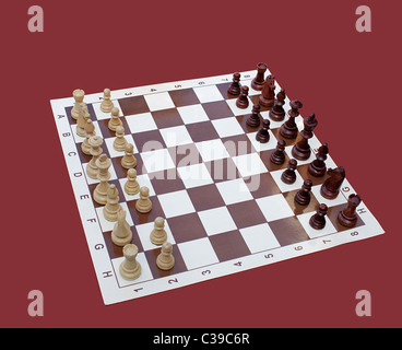chessboard with wooden chessmen over purple background Stock Photo