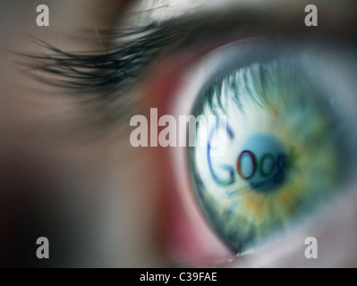 The Google search engine webpage being reflected in an eye. Stock Photo