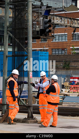 Engineers at work below a signal box at King's Cross Station, London. Stock Photo