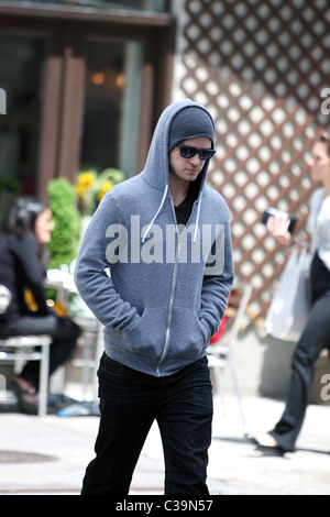 Justin Timberlake wearing a grey hoodie and sunglasses walking in SoHo New York City, USA - 11.05.09 Stock Photo