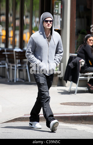 Justin Timberlake wearing a grey hoodie and sunglasses walking in SoHo New York City, USA - 11.05.09 Stock Photo