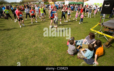 group of people limbering uip before local running event Stock Photo