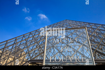 The Louvre Museum entrance sign at the Glass Pyramid, Paris Stock Photo