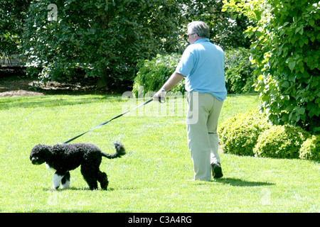 White House Horticulturist Dale Haney  walks with Bo, the new dog of U.S. President Barack Obama, outside the Oval Office of Stock Photo