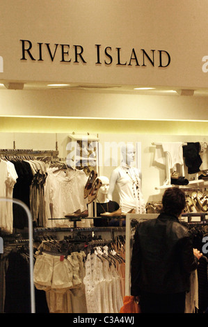 Man browsing inside a River Island store, London, England Stock Photo