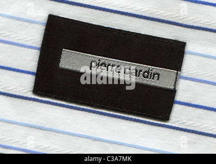 Detail of the label in the collar of a man's striped shirt from the clothing Pierre Cardin Stock Photo