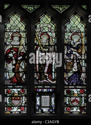 A Stained glass window by the Kempe Studios, St Mary's Church, Mucklestone, Staffordshire; Saints Catherine, Cecilia & Agnes Stock Photo