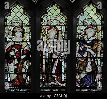 A Stained glass window by the Kempe Studios, St Mary's Church, Mucklestone, Staffordshire; Saints Catherine, Cecilia & Agnes Stock Photo