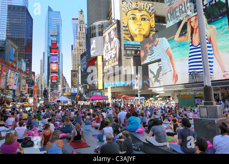 People participate in a yoga event in Times Square New York City. June 21, 2010. Stock Photo