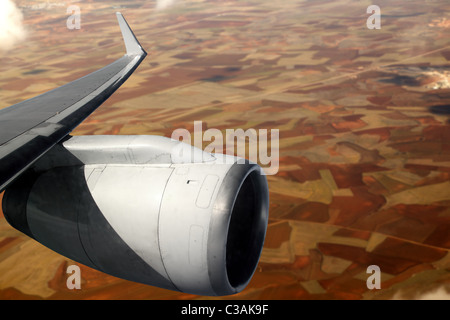 airplane wing aircraft turbine flying over agriculture fields Stock Photo