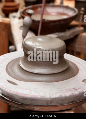 Making red clay pottery. The potter shapes red clay by hand to make a ...