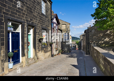 Traditional stone houses and village pub on the main street through Heptonstall, near Hebden Bridge, West Yorkshire, UK Stock Photo