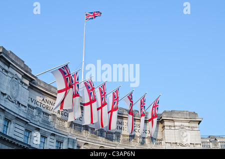 White Ensign flags and a Union jack flag above Admiralty Arch for Royal wedding Prince William to Catherine Kate Middleton.  Uk Stock Photo