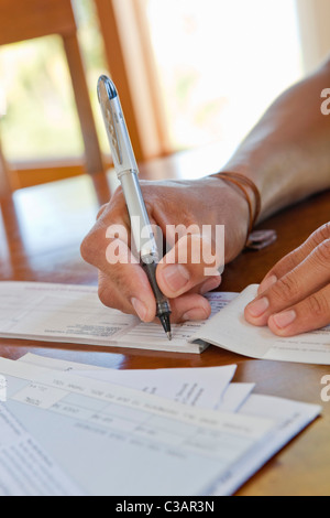 close-up of hand writing check Stock Photo