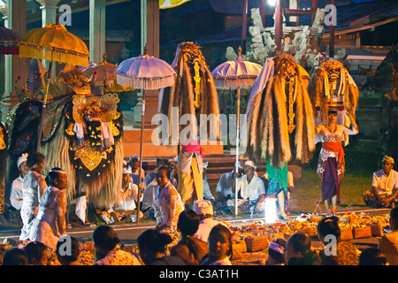 A BARONG COSTUME and LION MASKS used in traditional LEGONG dance at a temple anniversary - UBUD, BALI Stock Photo