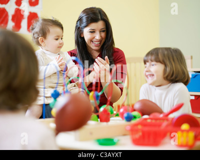 female toddler and 2-3 years girls playing with toys in kindergarten. Horizontal shape Stock Photo