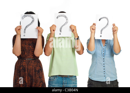 Three casual people standing in a line and holding questions marks isolated on white background Stock Photo
