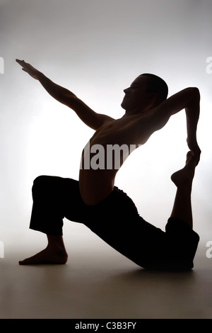 Profile of sporty guy doing physical exercise Stock Photo