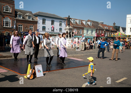 A young boy watching tap dancers at Wallingford town fair, Oxfordshire UK Stock Photo