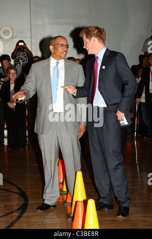 Prince Harry laughs with Prince Seeiso of Lesotho as they watch children play during a visit to the Harlem Children's Zone in Stock Photo