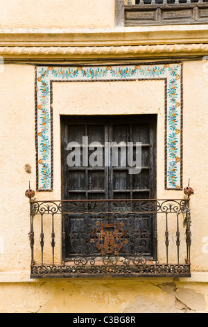 Balcony with shutters / shuttered door / doors and iron / metal railings on a Spanish house in the White city of Ronda, Spain. Stock Photo