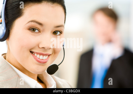 Face of attractive Customer Support Representative with a smile Stock Photo