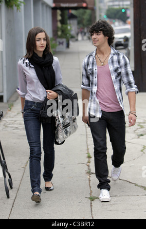 Joe Jonas of the Jonas Brothers and Camilla Belle walking down the