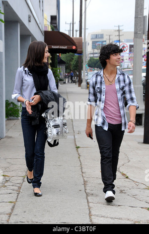 Joe Jonas of the Jonas Brothers and Camilla Belle walking down the