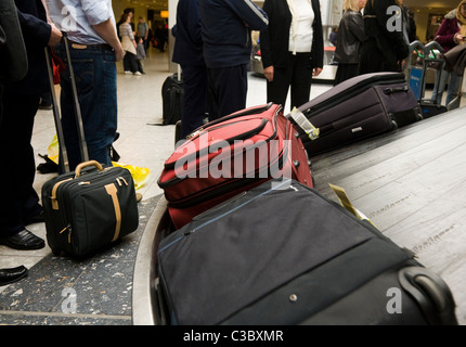 Suitcase on the luggage baggage reclaim carousel belt at London Heathrow LHR International airport, terminal T 3 /  T three. UK. Stock Photo