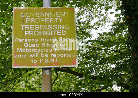 Sign covered in moss warning about using motorcycles or quads on Government Property Stock Photo