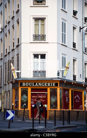 Man walks past a boulangerie bakers shop in Rue Marcadet 18e Montmartre Paris Stock Photo