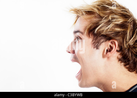 side profile of a young man screaming Stock Photo