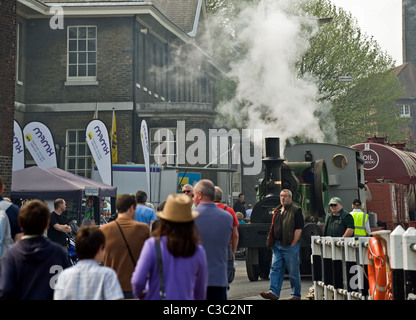 The small steam engine Sydenham moving through visitors at the Chatham Historic Dockyard. Stock Photo