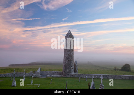 Dawn mist around Temple Finghin and round tower, Clonmacnoise Monastery, County Offaly, Ireland. Stock Photo