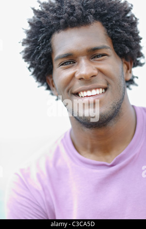 portrait of young african american guy looking at camera near the sea. Vertical shape, head and shoulders Stock Photo
