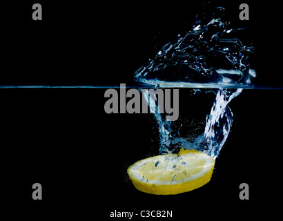 lemon splashing in pure water isolated on black background Stock Photo