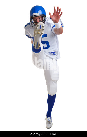 Photo of an American football player kicking, isolated on a white background. Stock Photo