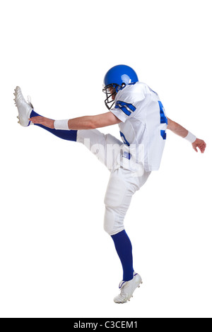 Photo of an American football player kicking, isolated on a white background. Stock Photo