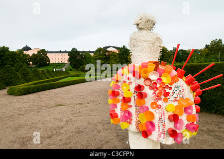 Bizarre sculpture in the Botanic Gardens and view of Uppsala Slott in Sweden. Stock Photo
