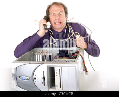irritated businessman having computer problems phoning hotline Stock Photo