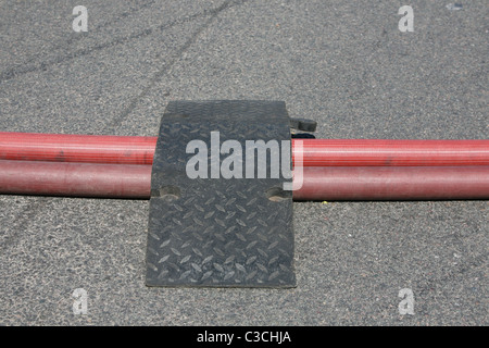 ramps put in place by firefighters to protect there hoses from traffic Stock Photo