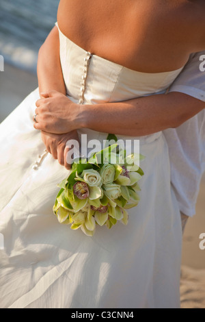 bridal couple hugging on beach Stock Photo