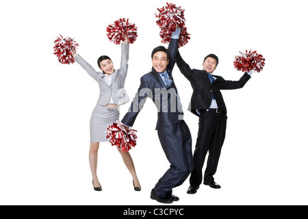 A team of businesspeople cheering with pompoms Stock Photo