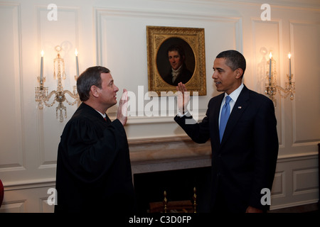 US President Barack Obama is given the Oath of Office for a second time by Chief Justice John G. Roberts, Jr.  in the Map Room Stock Photo