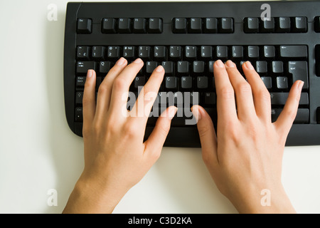 Above view of female hands typing documents or networking Stock Photo