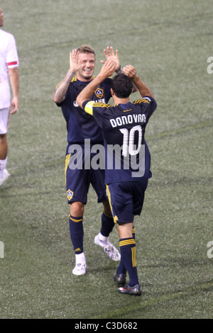 Landon Donovan #10 and David Beckham #23 of the LA Galaxy  celebrate a goal in the first half by teammate Eddie Lewis #6 during Stock Photo